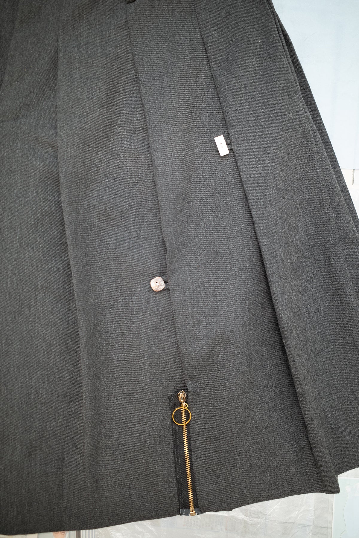 Pleated Skirt with Button and Zipper Detail